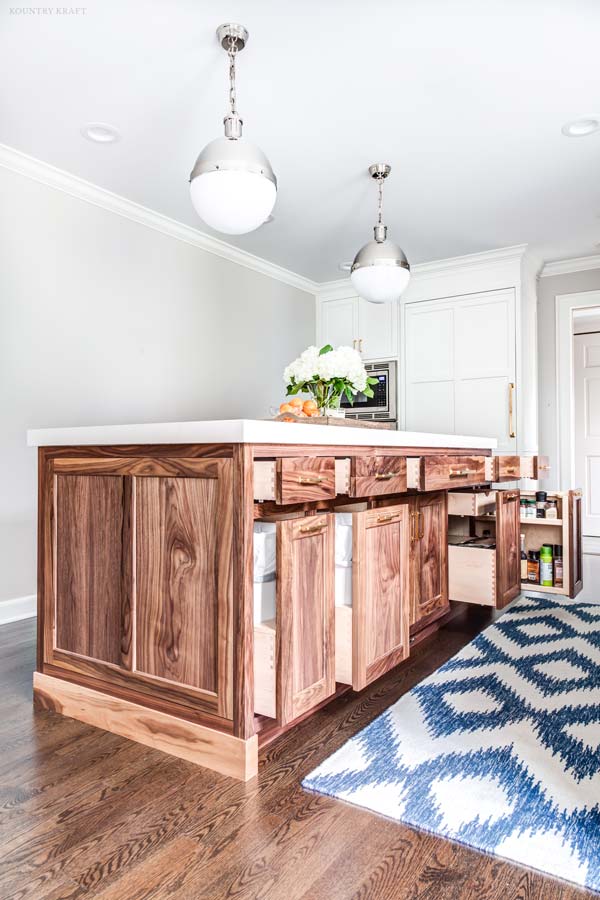 Painted White Cabinets and Walnut Wood Cabinets mixing kitchen cabinet styles and finishes in a kitchen