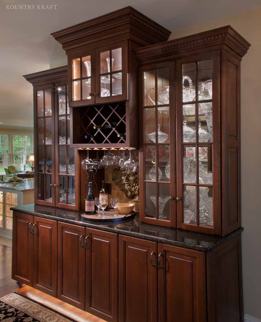 Custom Home Bar with Kountry Kraft Cabinets to Display Glass Ware and Wine this custom home bar displays the family’s collectables while they aren’t being used