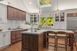 Kitchen and cabinet showroom inspiration featuring custom walnut and white cabinetry, a large island, and vaulted ceilings in Short Hills, NJ.